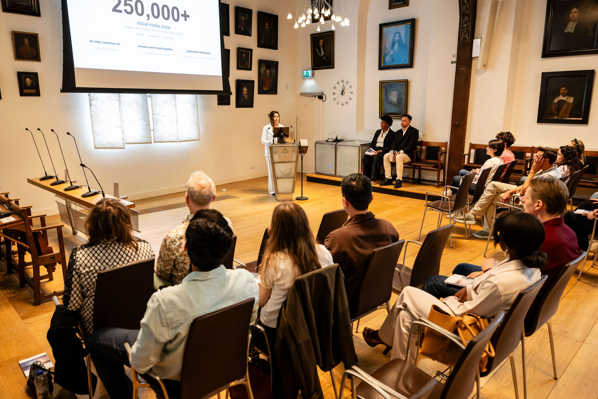 Kedma Hamelberg at the podium presenting research on 250,000+ social media posts